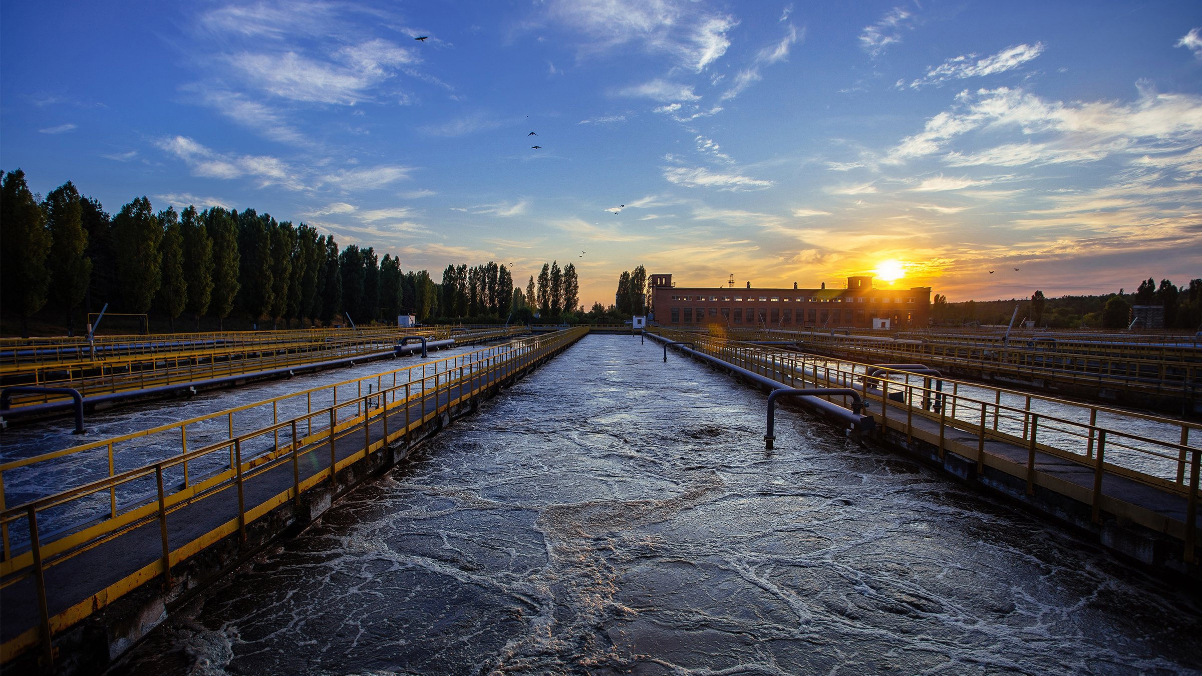 Modern wastewater treatment plant. Tanks for aeration and biological purification of sewage at sunset