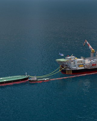 FPSO vessel overhead side view in the middle of the ocean with tugboat and towing vessel