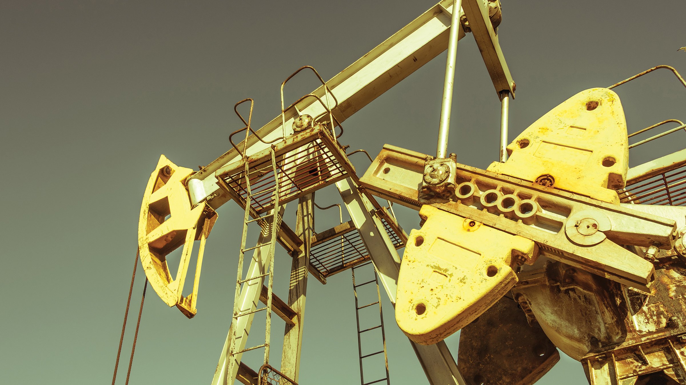 Oil Pumpjack well equipment against a sky background