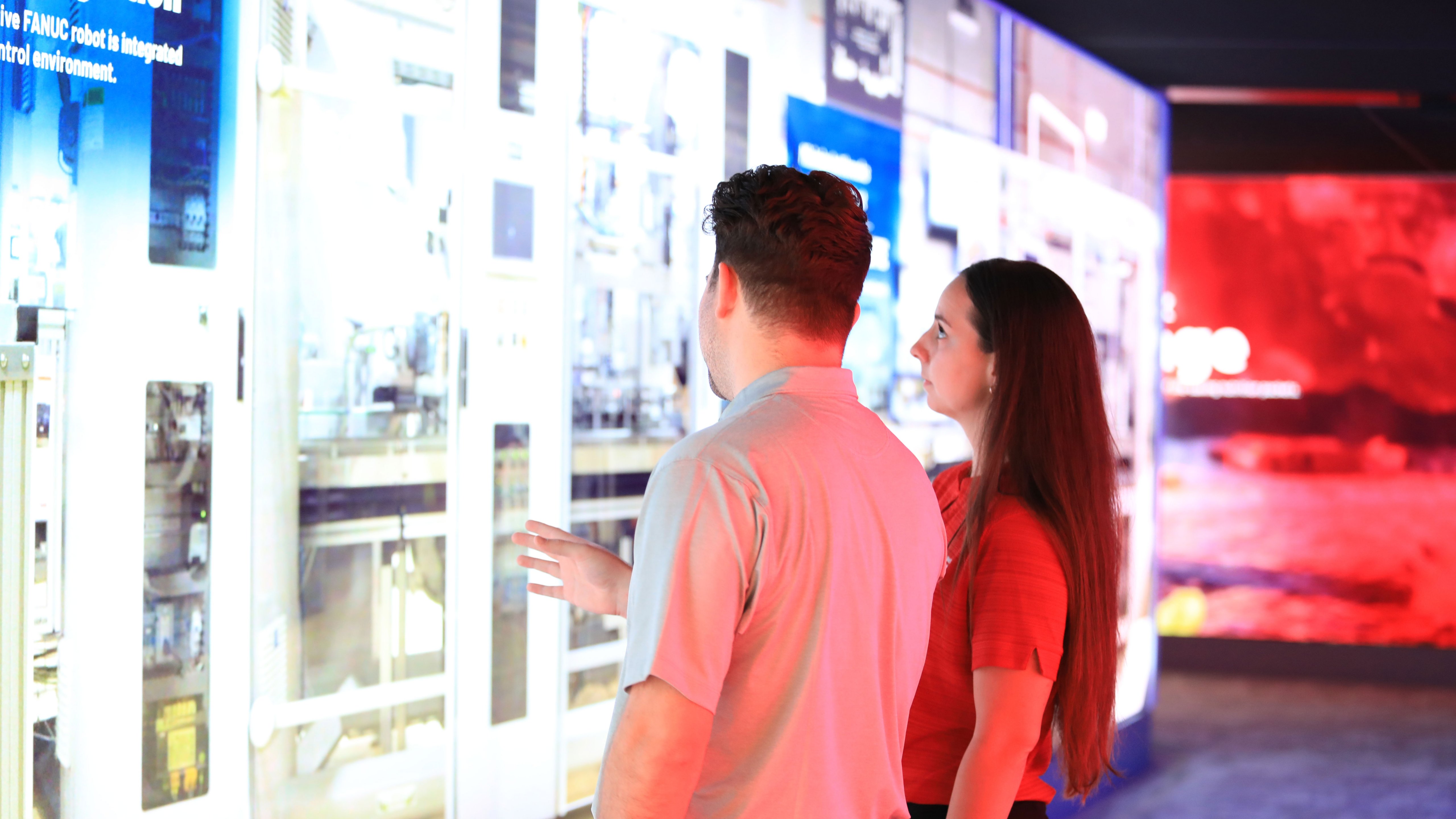 Two people watching stand exibition