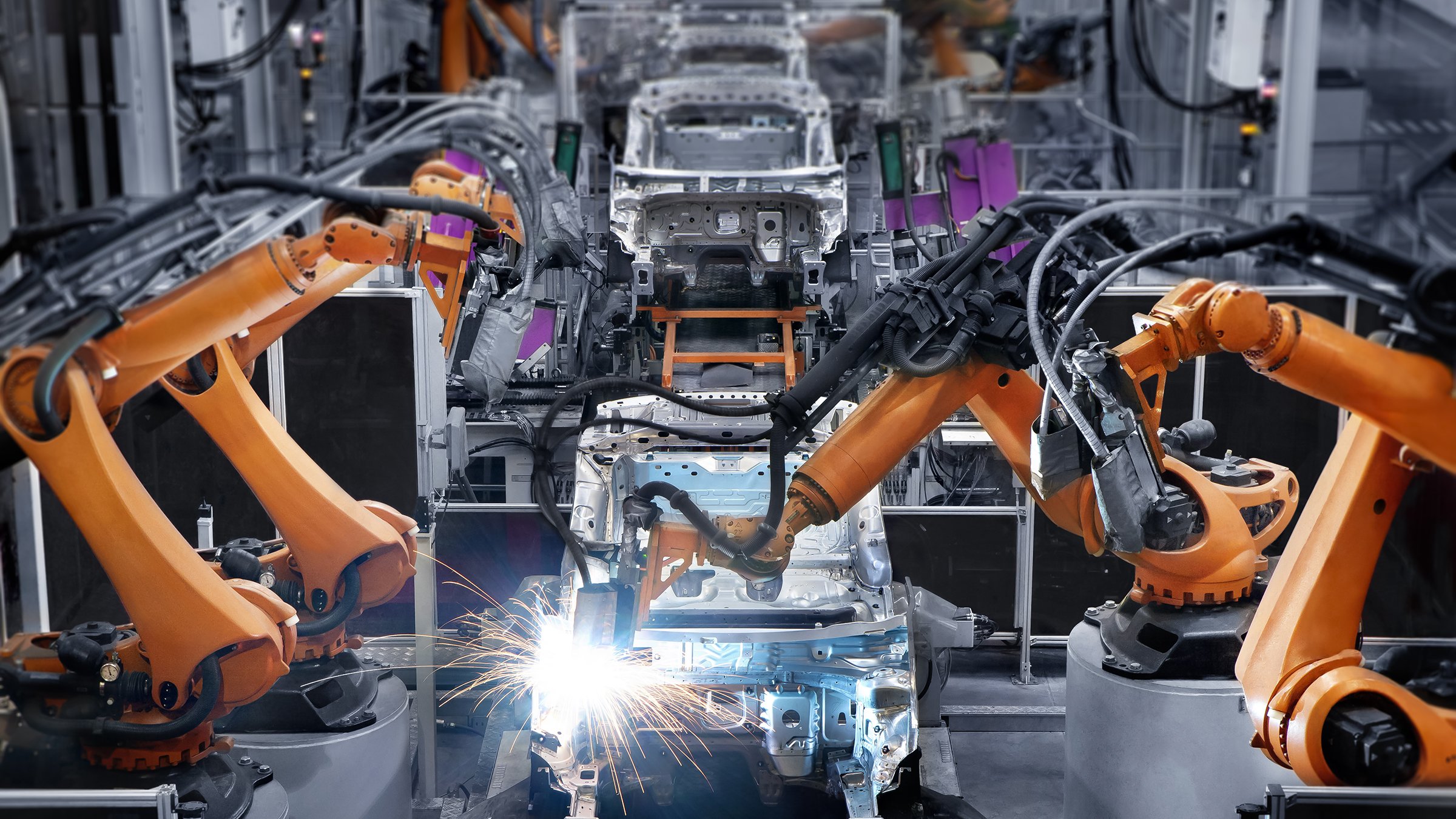 Robotic arms on an automobile manufacturing production line.