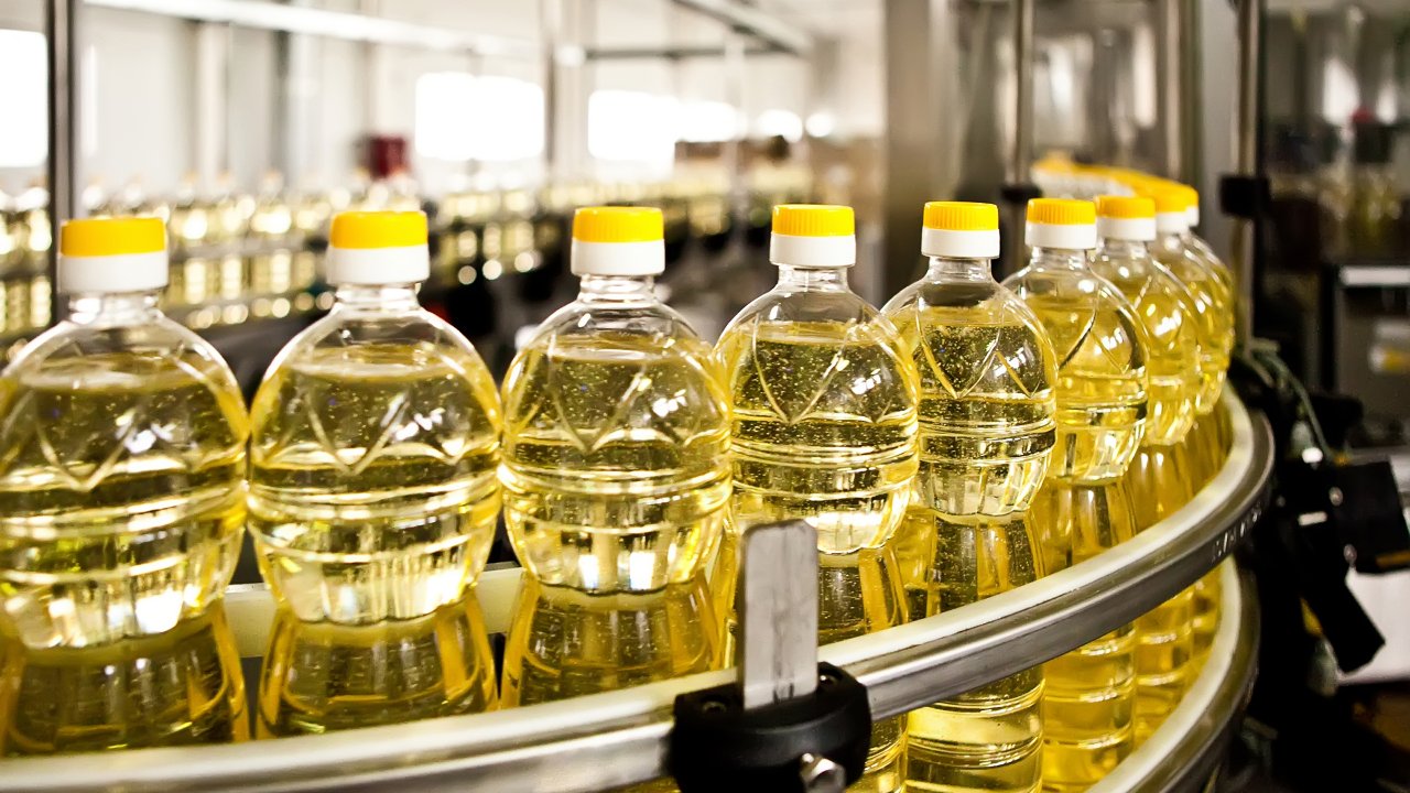 Sunflower oil in the bottle moving on production line. 