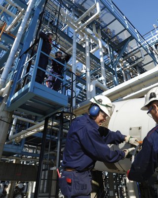 engineers working inside oil and gas refinery, pipelines and storage