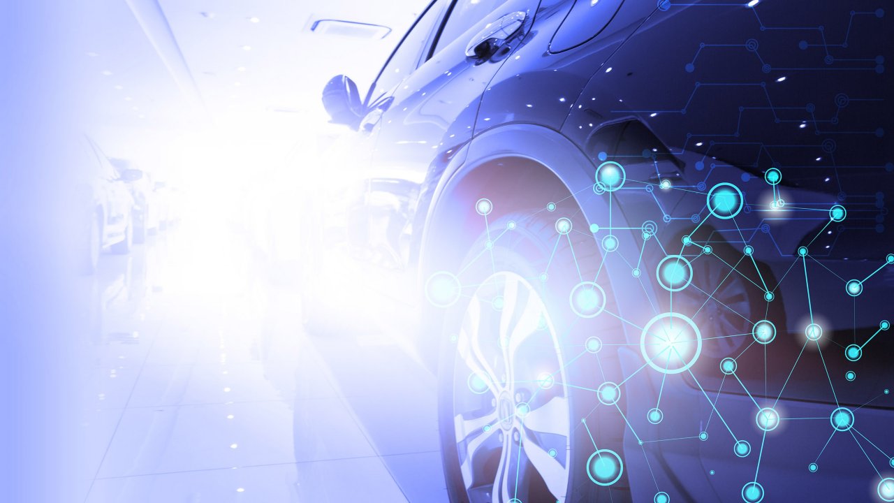 Futuristisches Bild eines Autos, bei dem der Fokus auf den Reifen liegt, mit überlagerter Grafik bestehend aus Lichtkreisen, die mit Linien verbunden sind.
