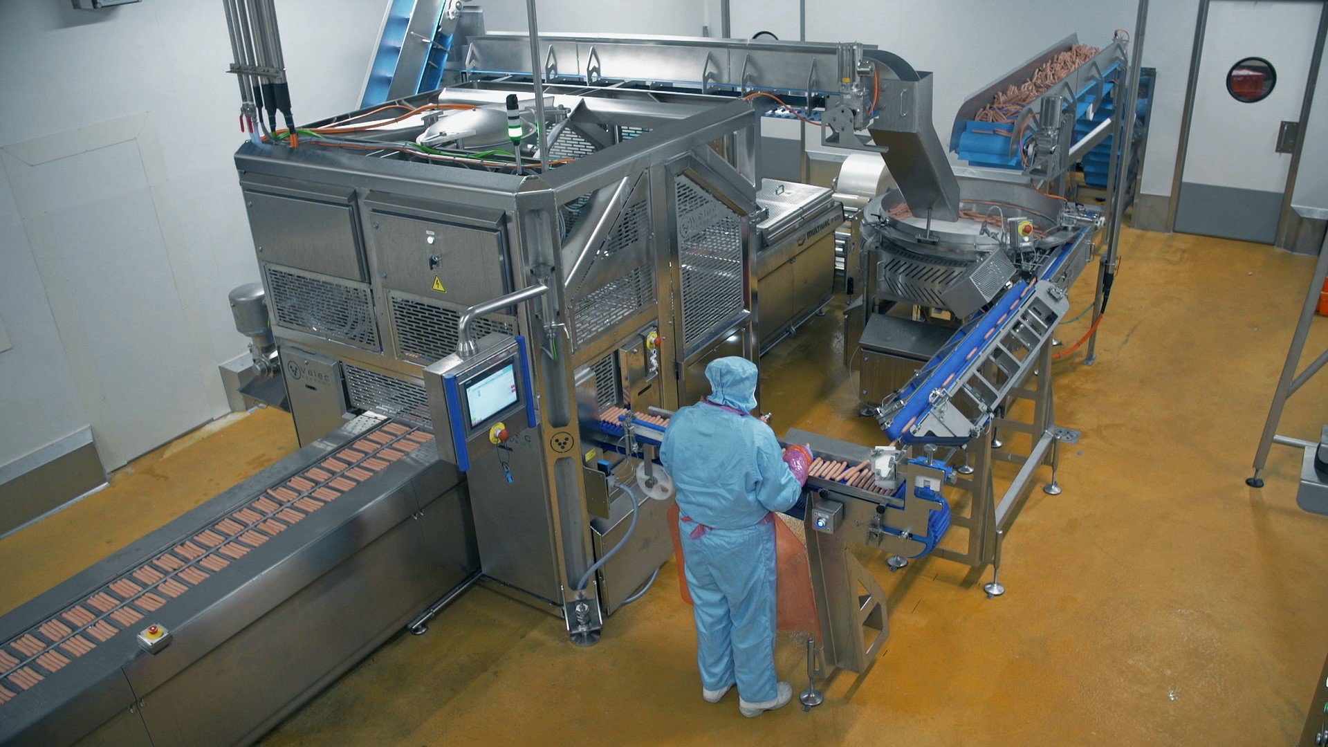 Industrial worker in blue overalls working at Velec Systems production line