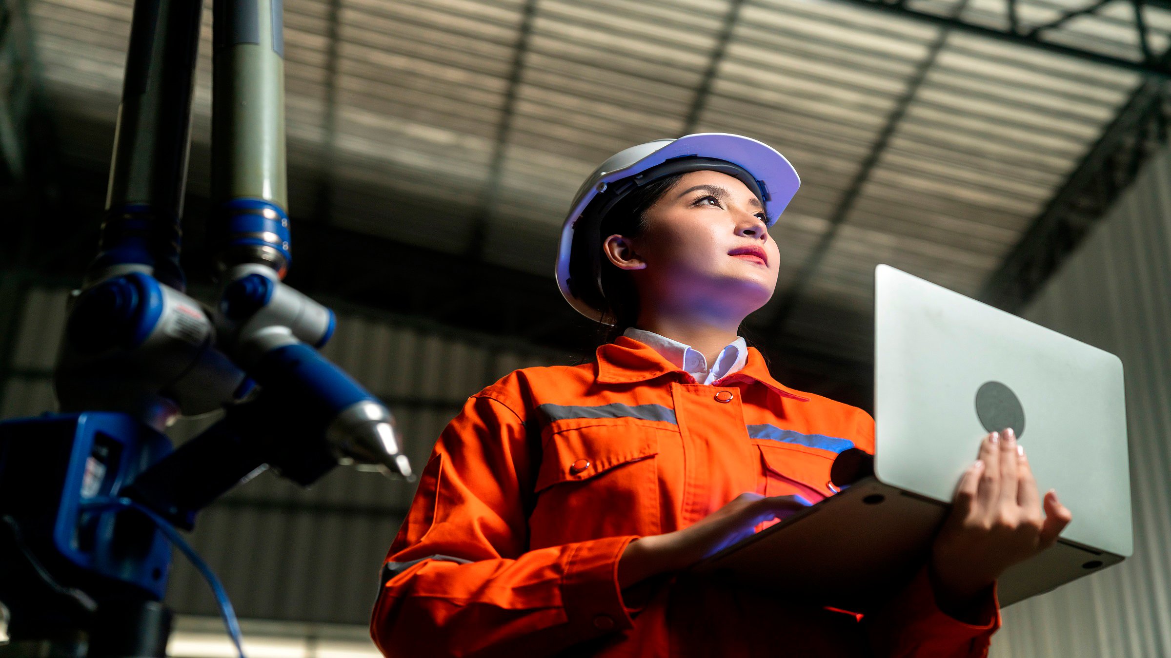 engineer specialist asian female and  technician maintenance inspect relay robot arm system with laptop  to control quality operate process work heavy industry 4.0 manufacturing smart factory