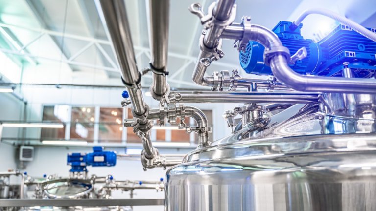 Interior of dairy factory with fermentation tank. Technology equipment at dairy farm. Sterile production.