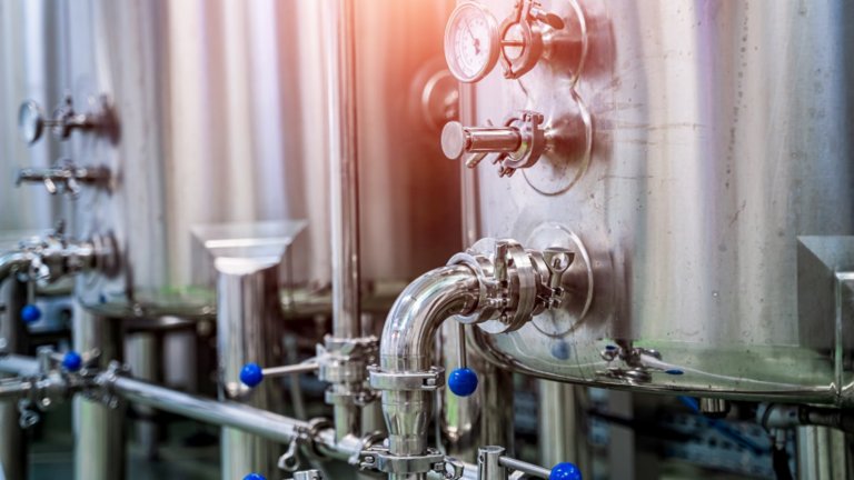 Dairy production. Apparatus for bottling milk products. Steel tanks at milk factory.