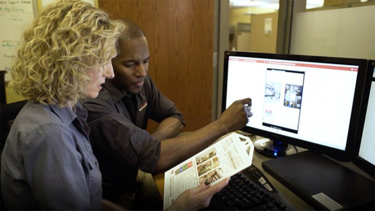 woman in man in front of monitor reviewing lockout-tagout procedures