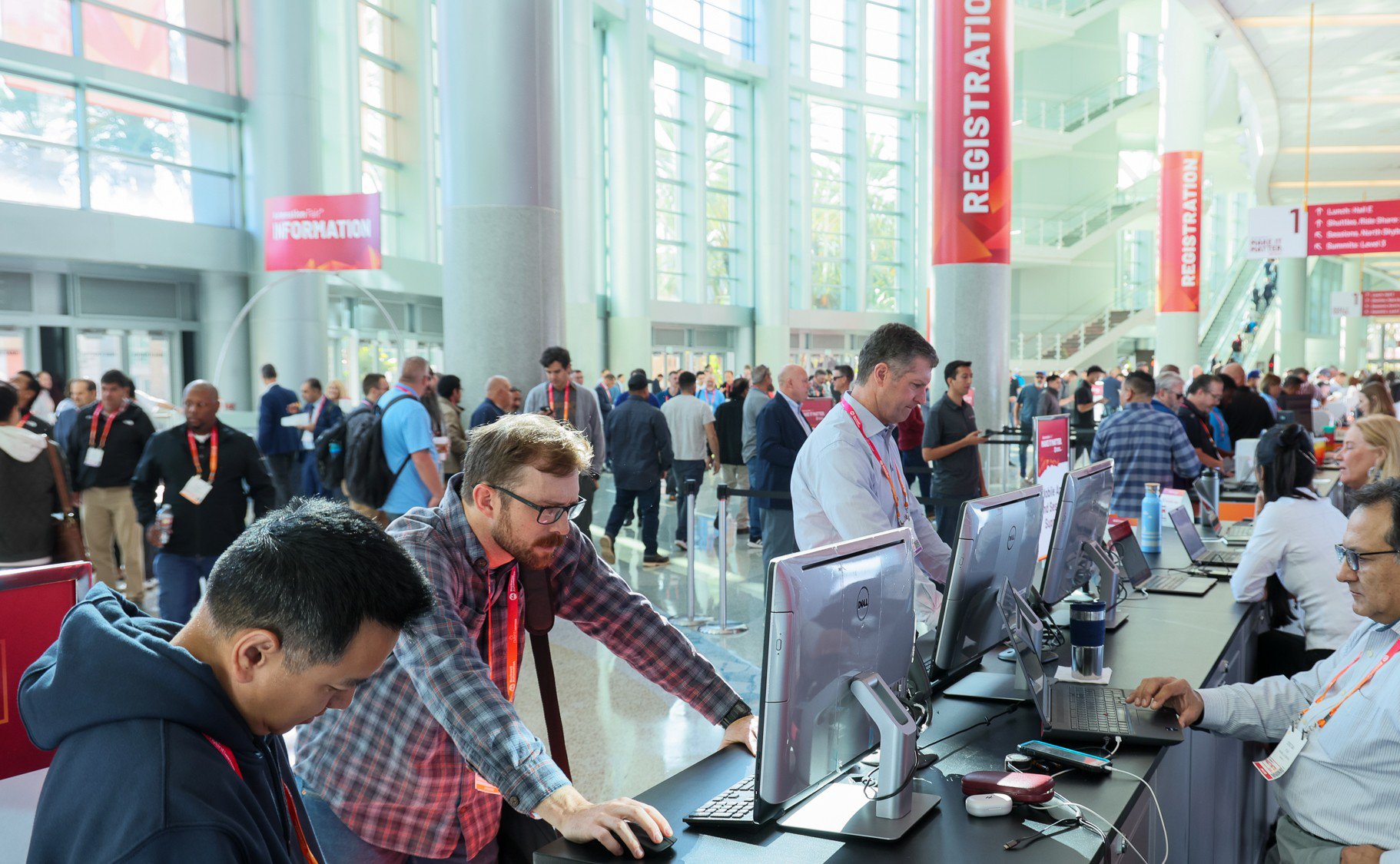 People at computers at a desk resgistering for Automation Fair