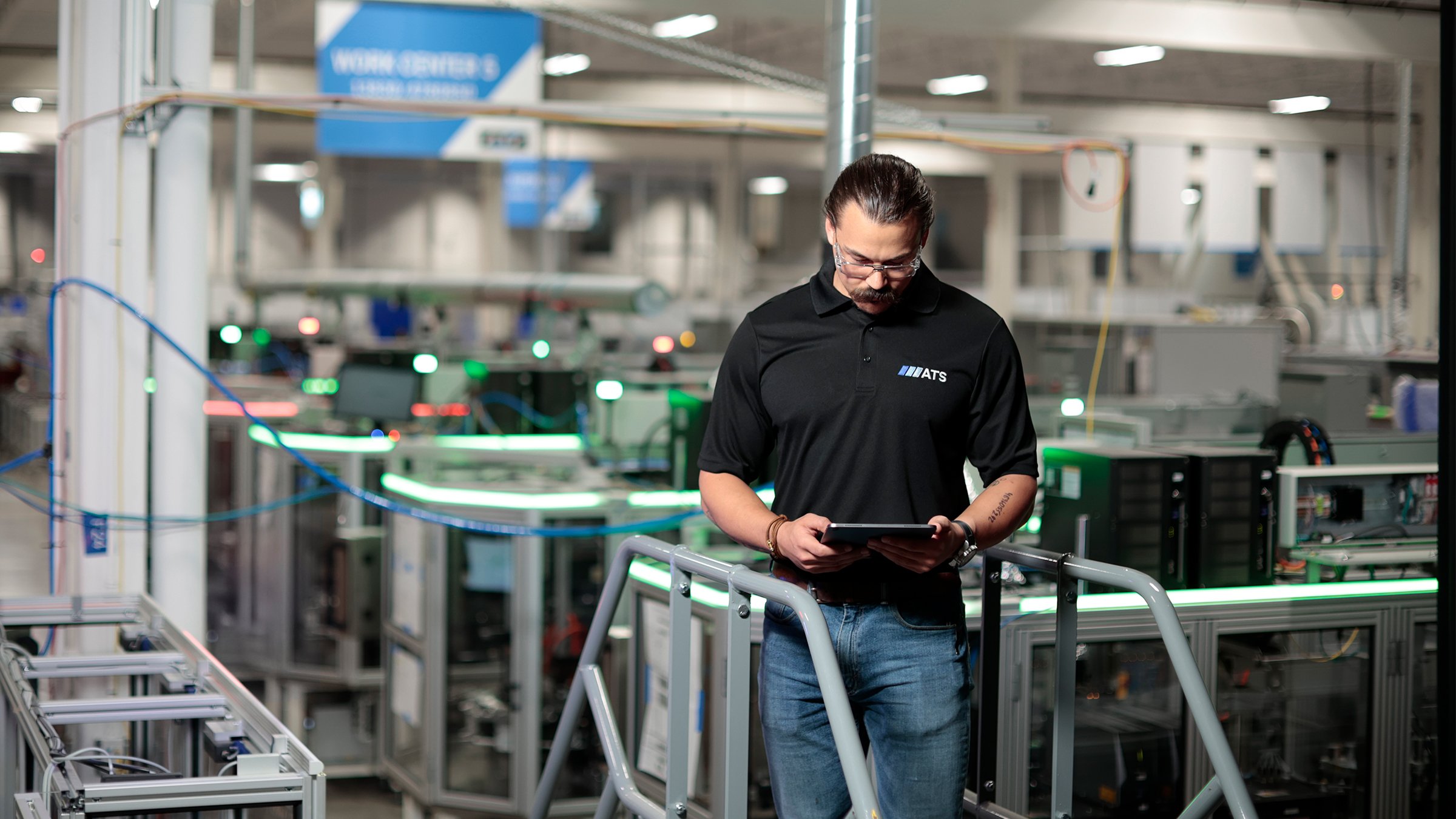 ATS, man in black shirt with tablet