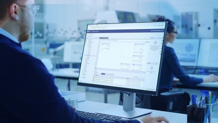 man looking at desktop monitor