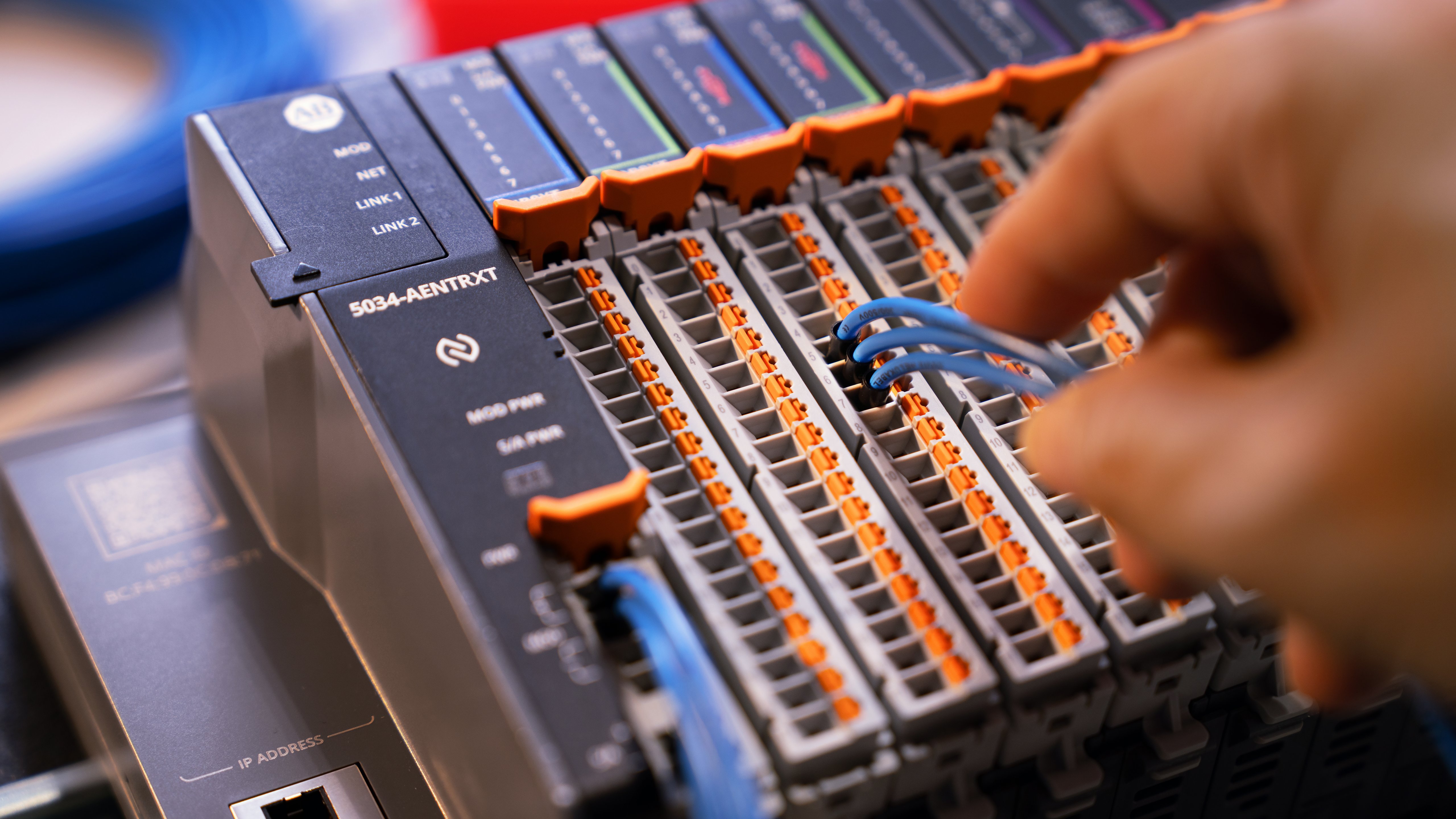 Close-up partial view of the PointMax I/O system. An engineer is wiring the I/O system