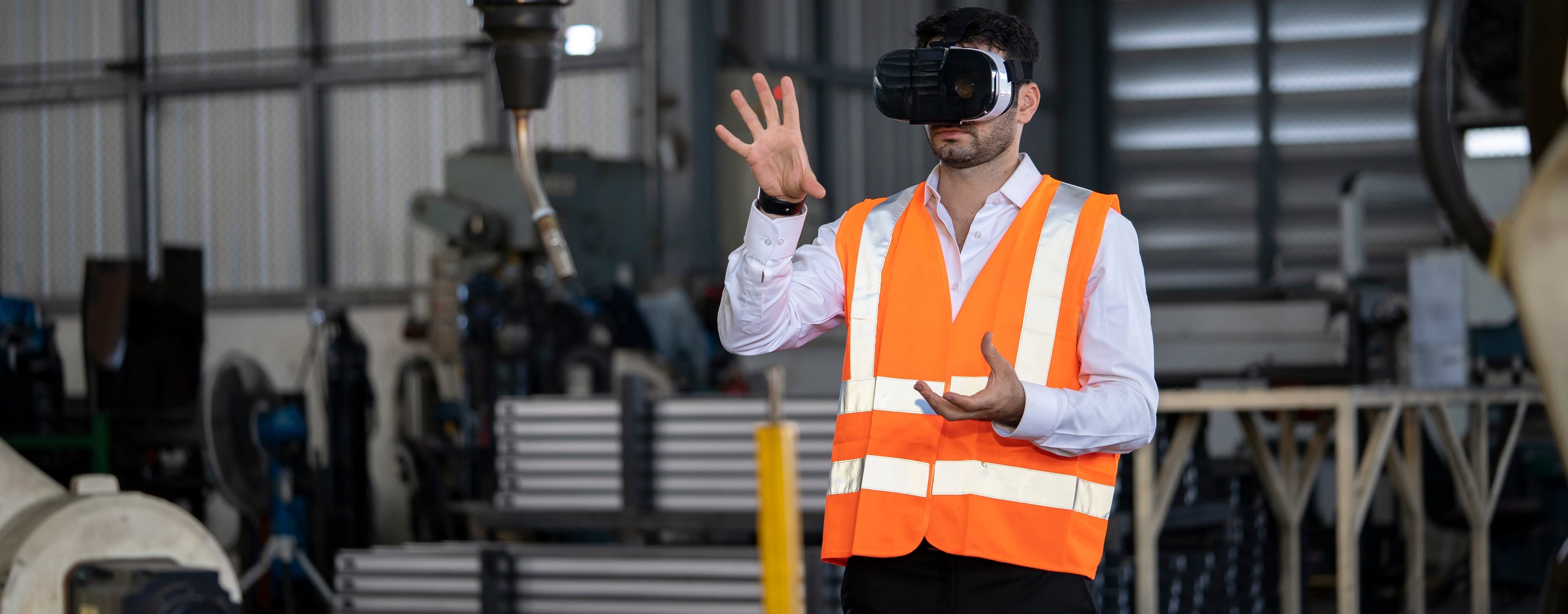 Engineer works with a HoloLens: place a virtual robotic arm into the production line