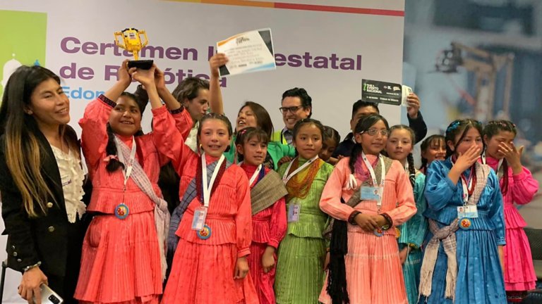 Group of children holding up awards and trophies