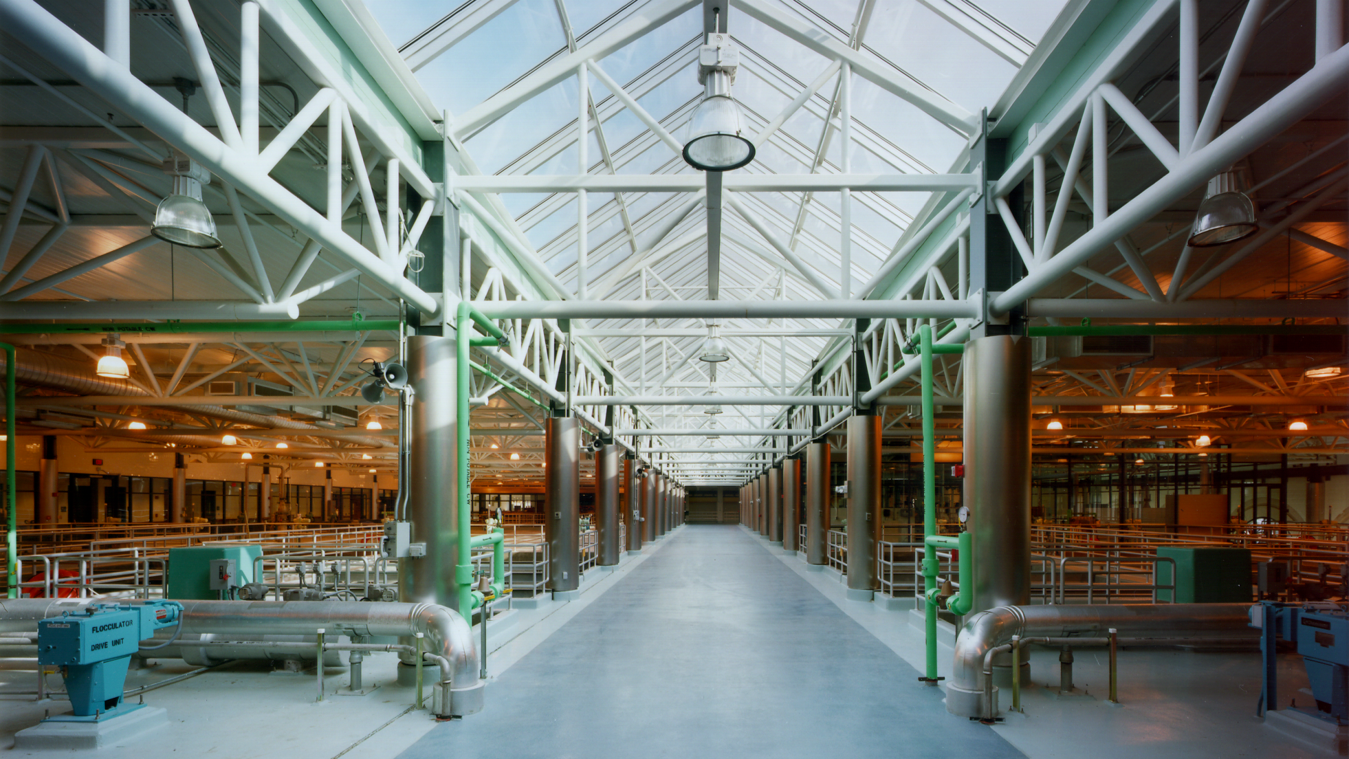 A large room with water treatment equipment and a skylight