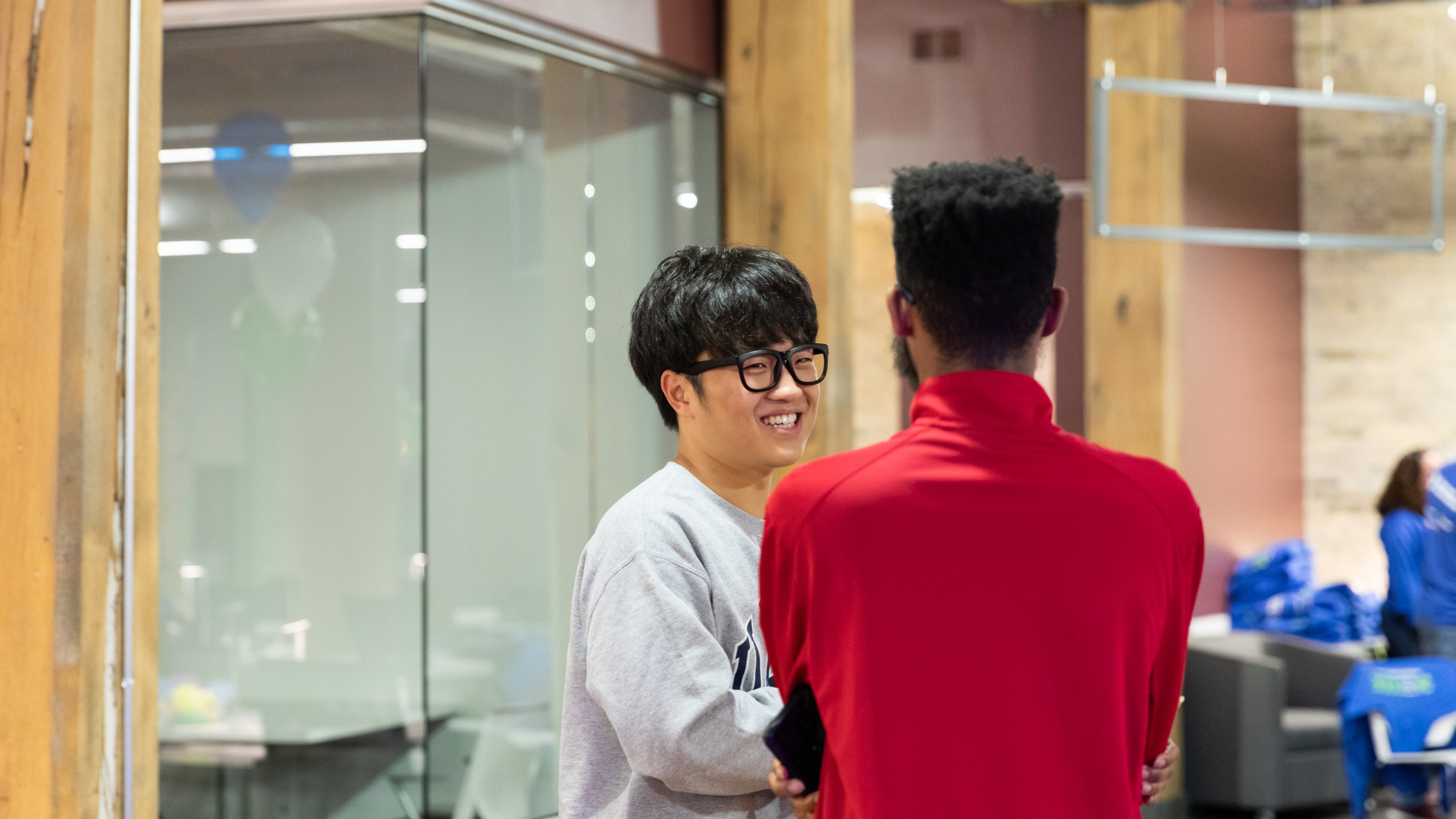 Two young male students talk and laugh at Rockwell Automation