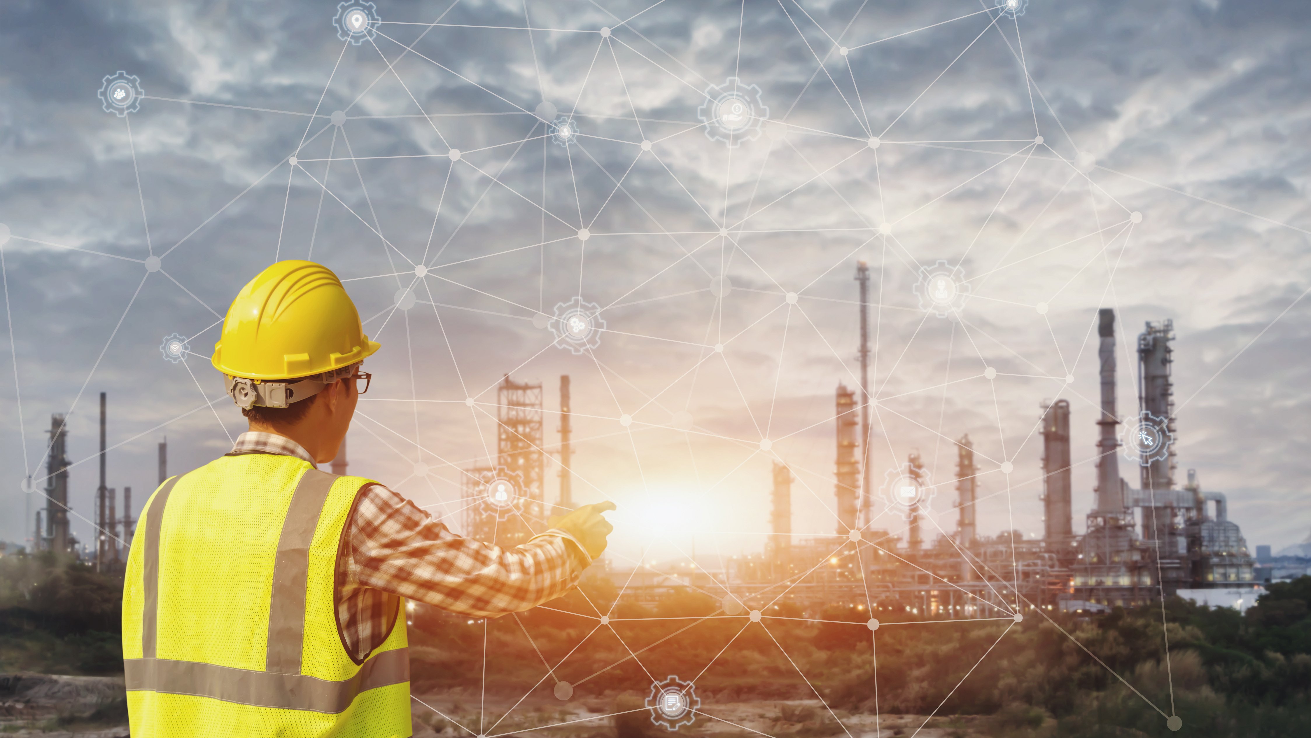 Businessman in safety helmet touching virtual interface screen as concept of industry