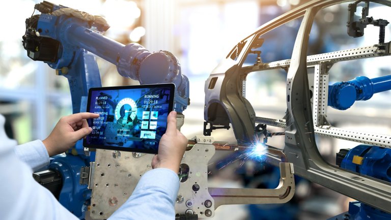Engineer hand using tablet with machine real time monitoring system software. Automation robot arm machine in smart factory automotive industrial Industry 4th iot , digital manufacturing operation.