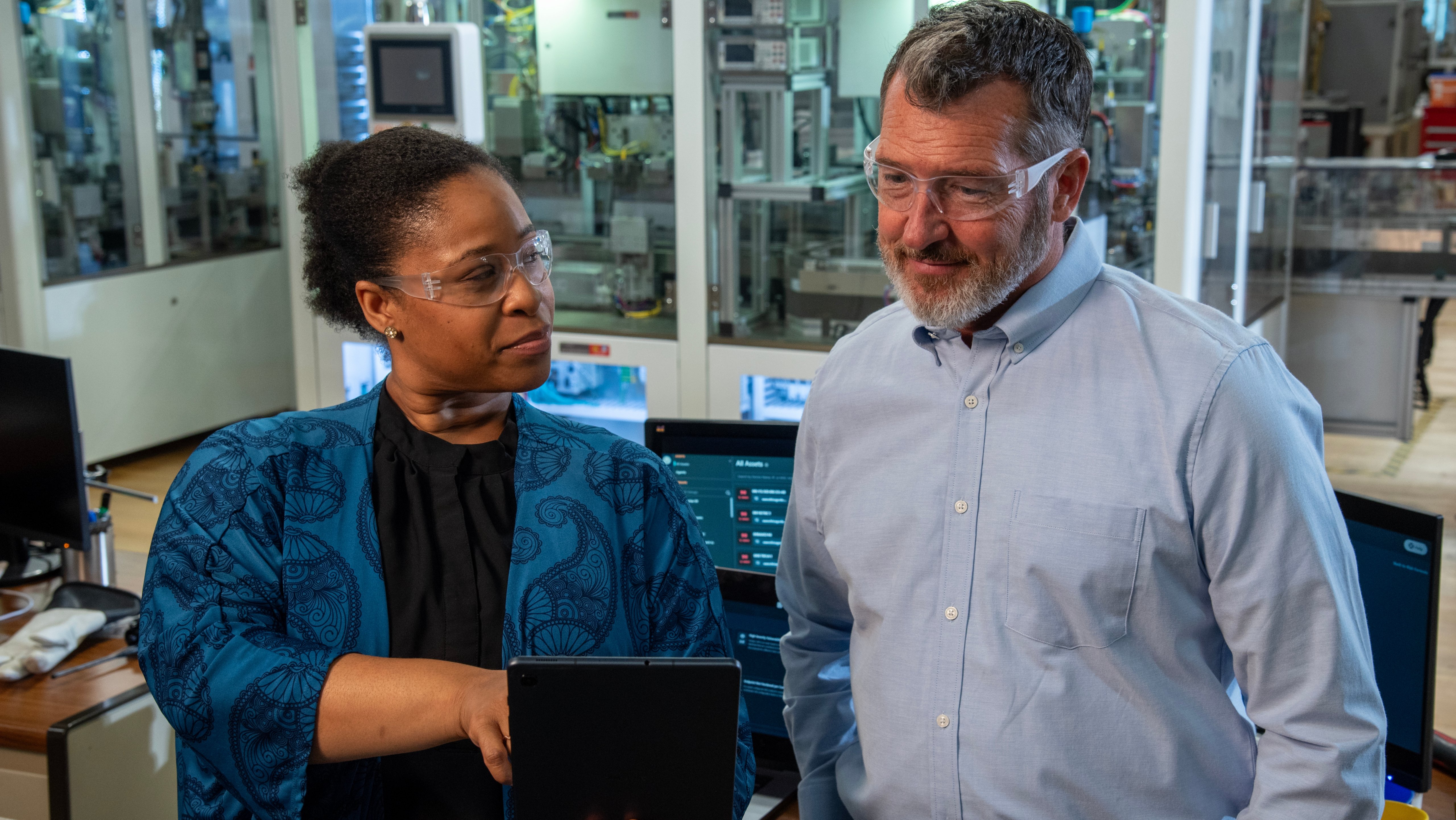 Two cybersecurity engineers looking at tablet