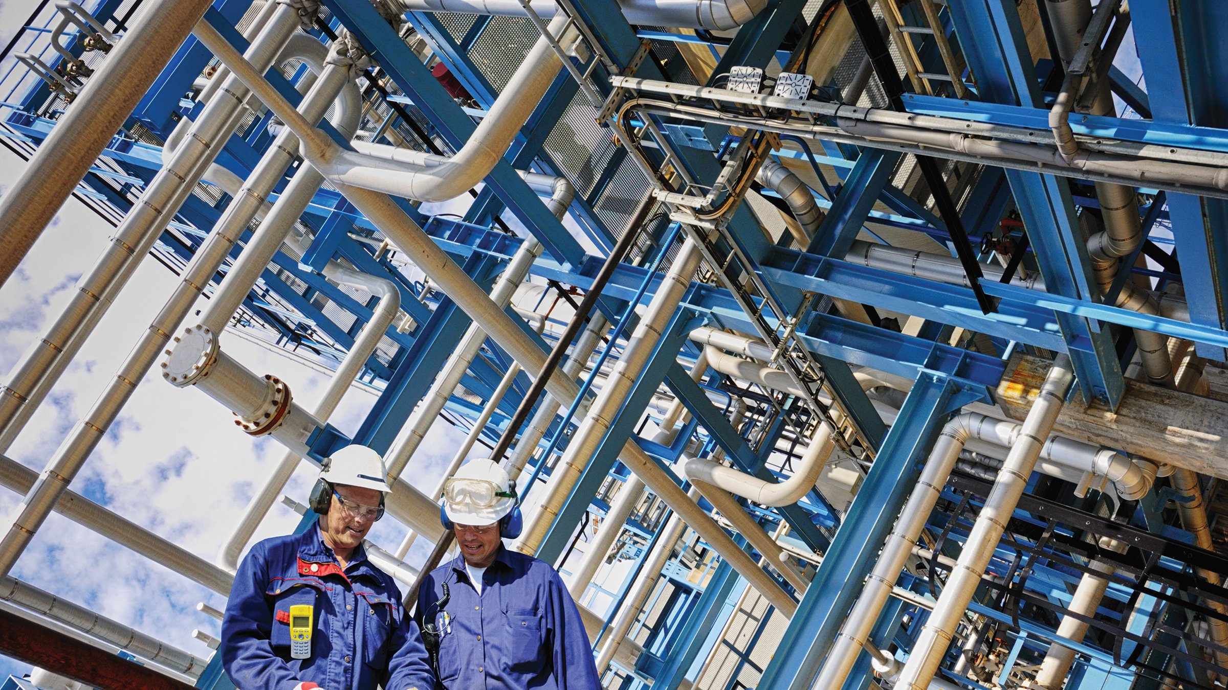 Aerial view of plant with two employess wearing hard hats