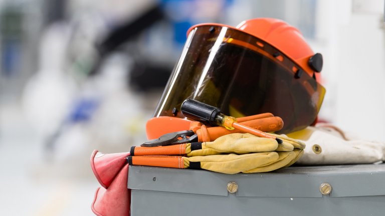 Orange safety helmut placed over other safety attire