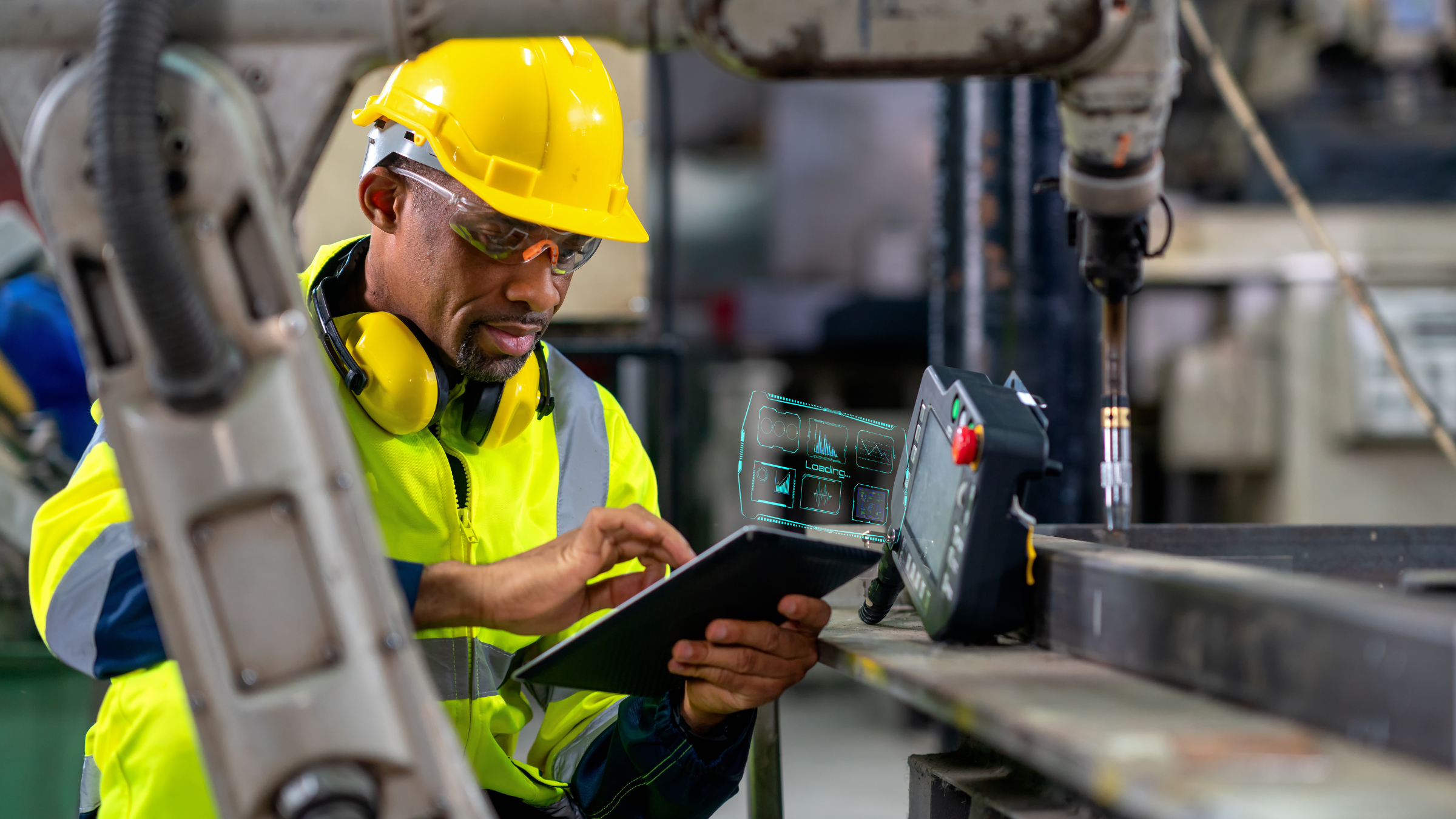 Male engineer working in manufacturing facility reviewing smart manufacturing product