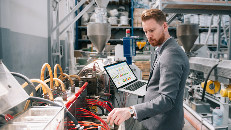 business man using laptop in plant