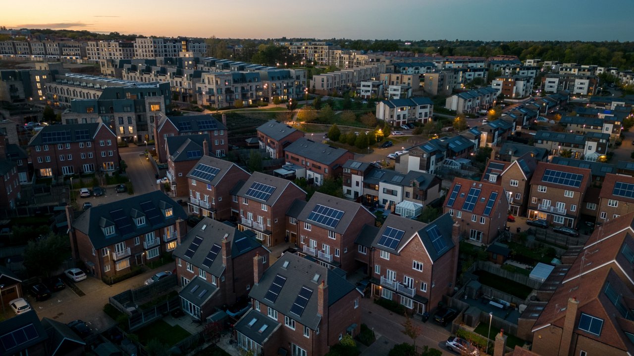 Aerial view of modern solar powered housing development at dusk