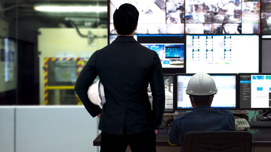  Process Control room and Industrial Automation in industry 4.0 technology trend concept. Engineer and director manager monitoring real time work automation machine process in smart factory