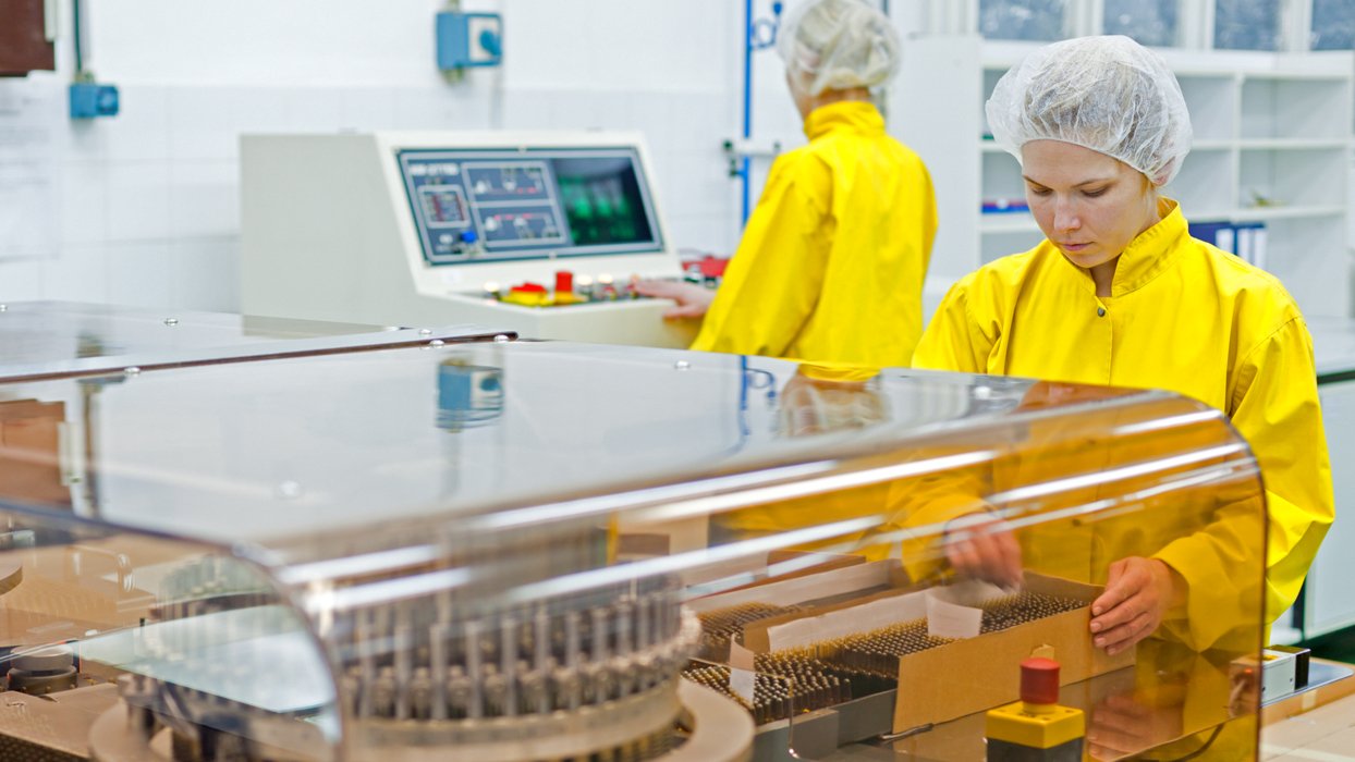 pharmaceutical worker handling vials