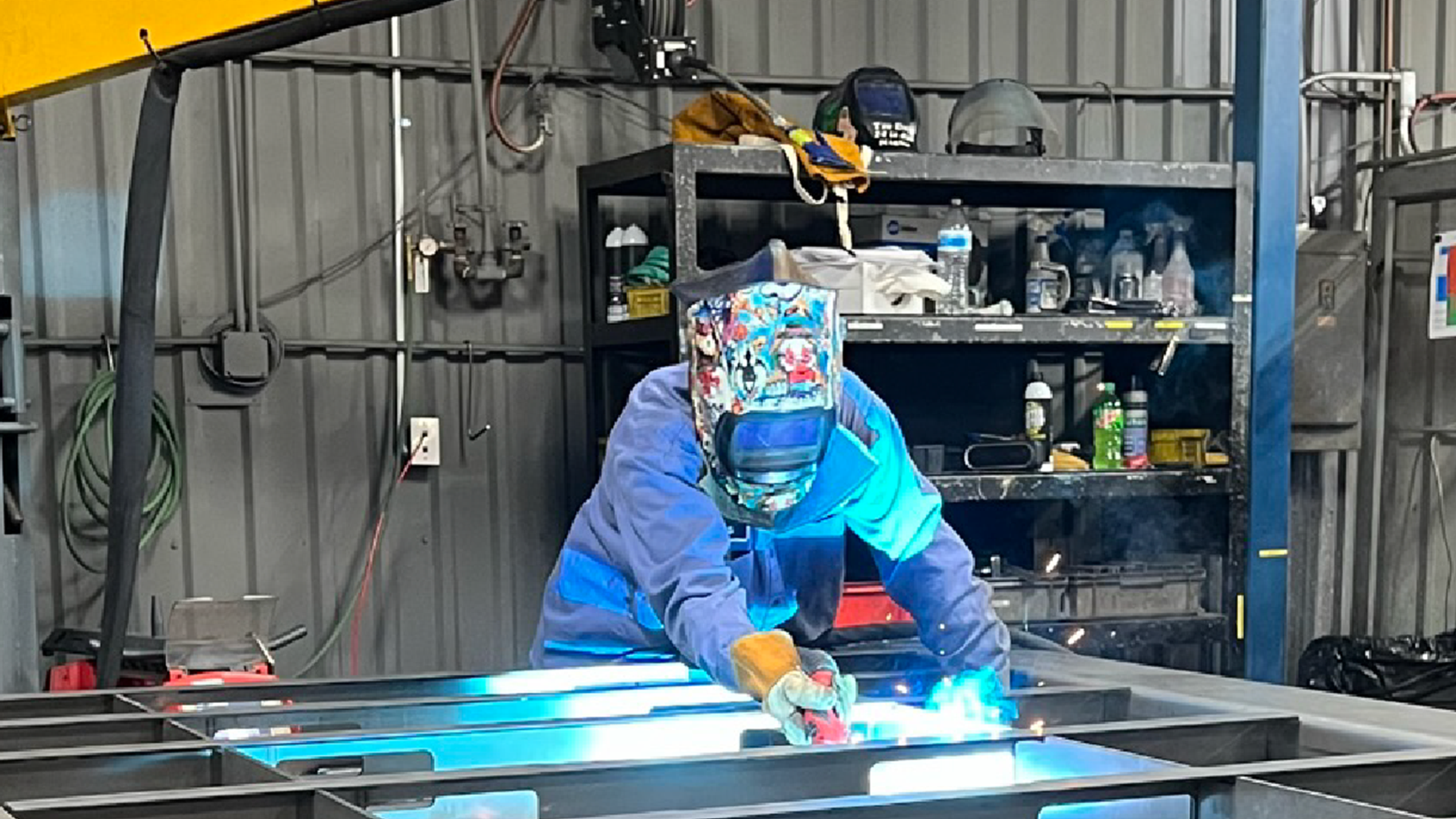 uniformed-worker-in-shop-performing-metal-work