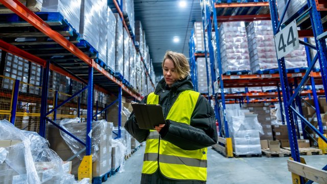woman-worker-checking-goods-with-digital-tablet