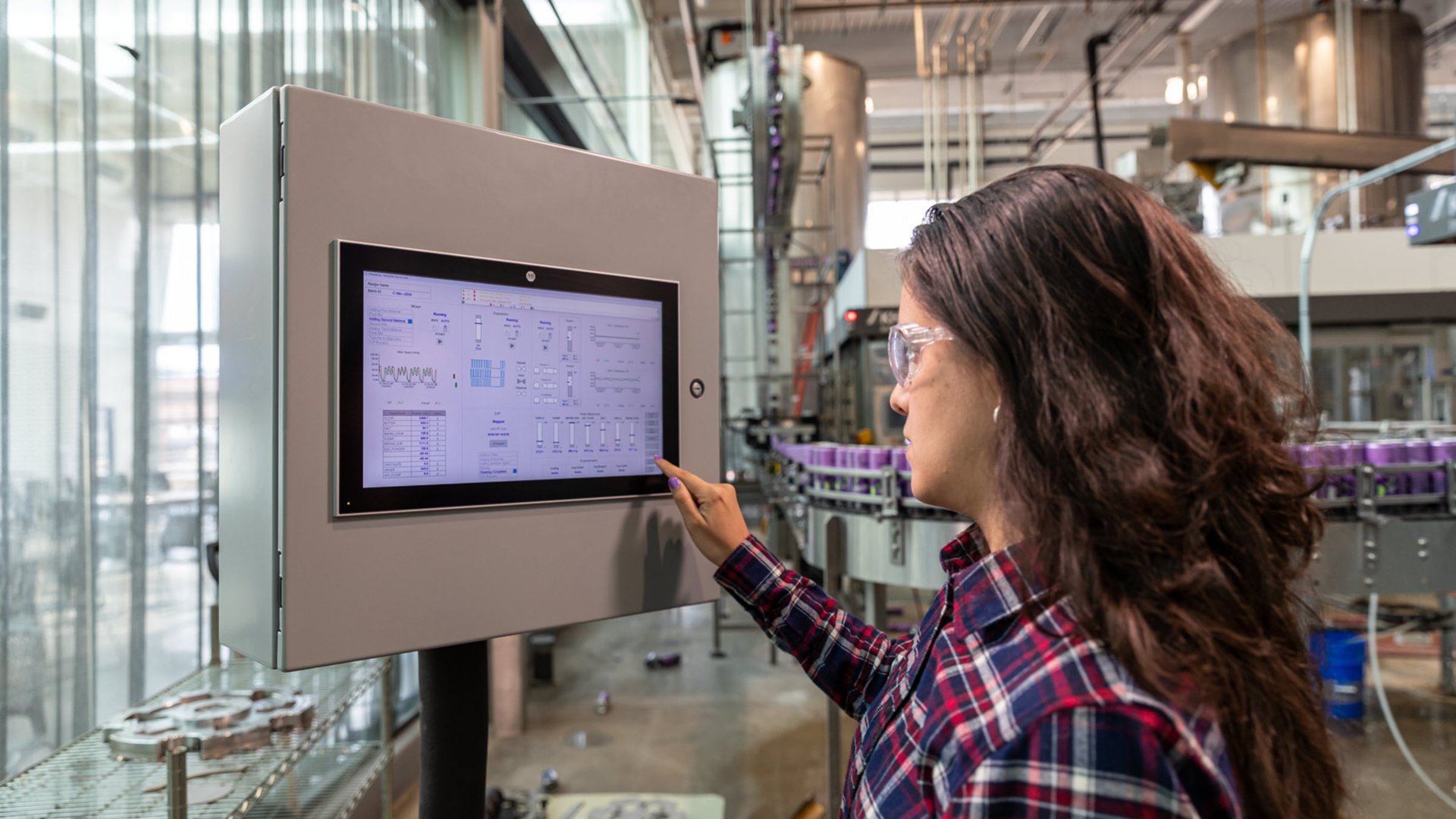 Women-in-safety-glasses-at-work-station-in-brewery