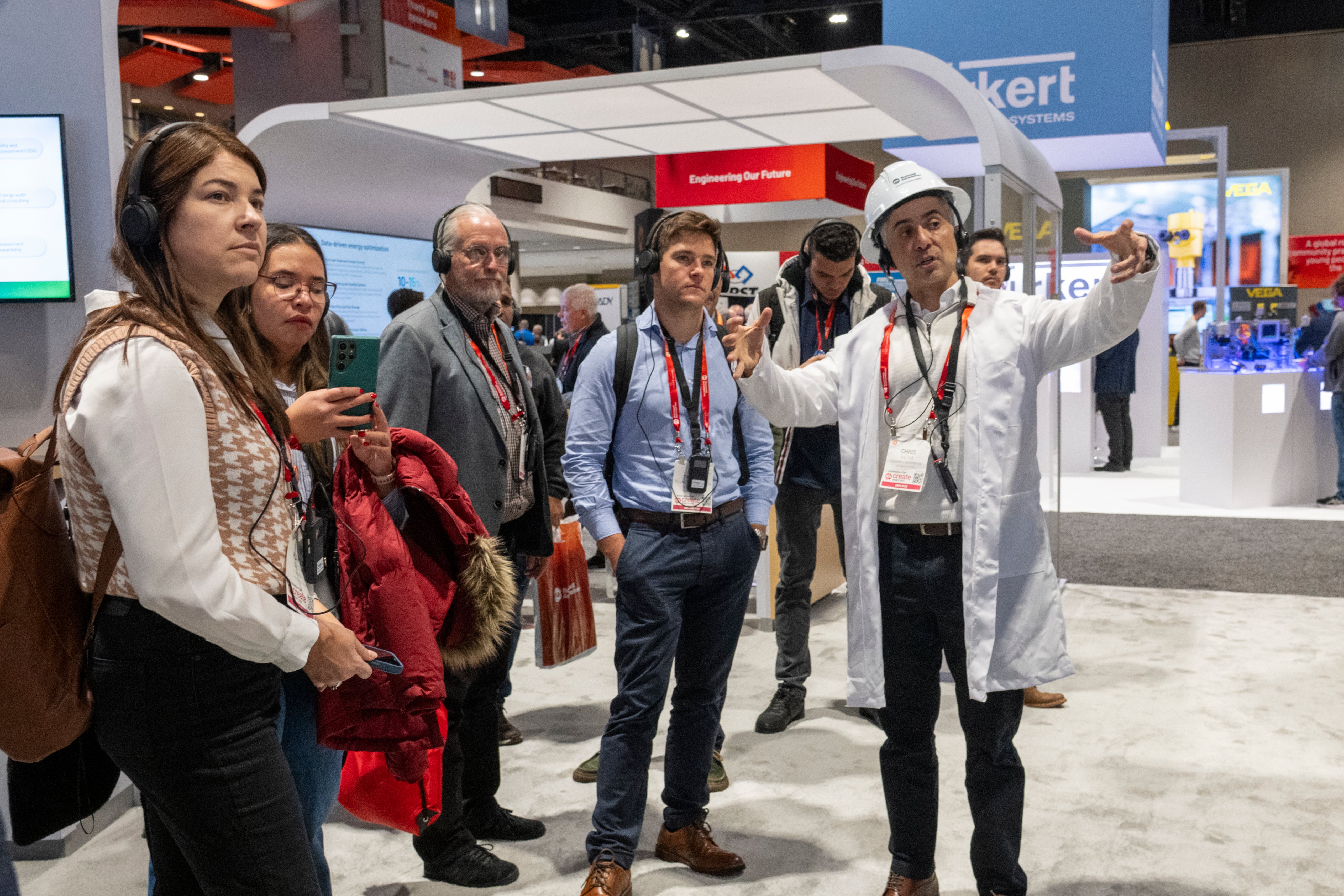 A man leads a group of people on a tour of the exhibit hall