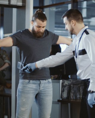 Passenger going through a manual check at airport security