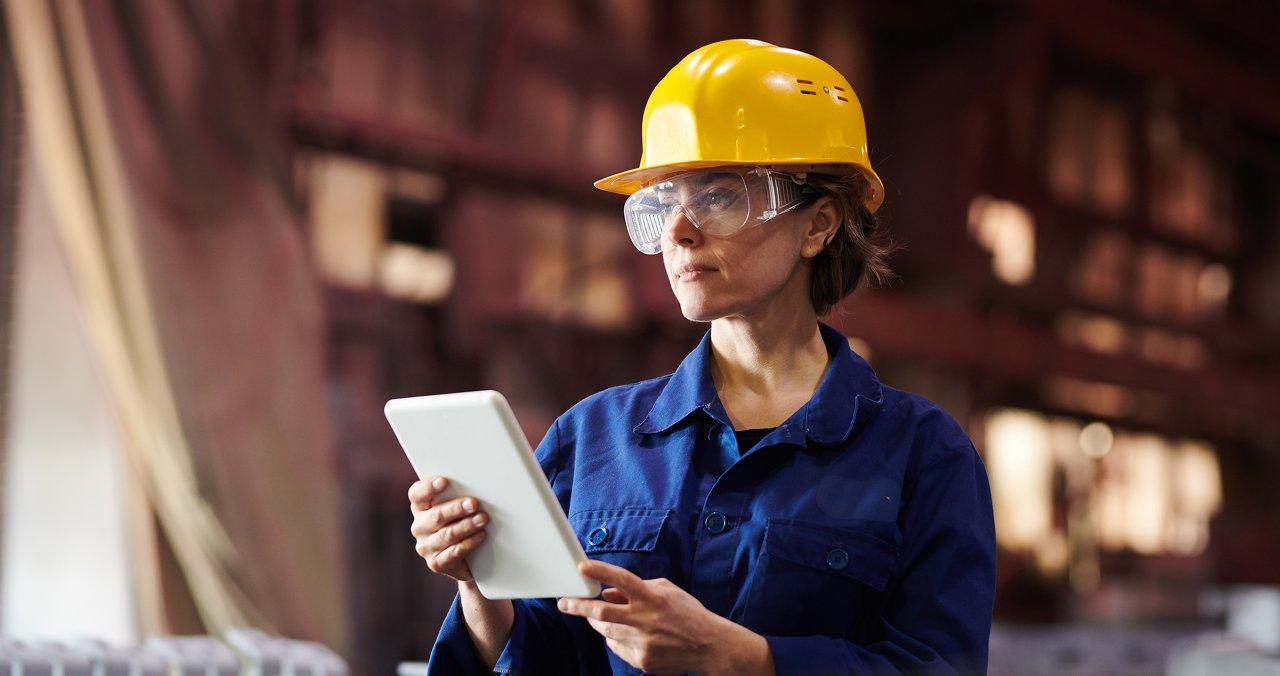 Woman looking at tablet in warehouse