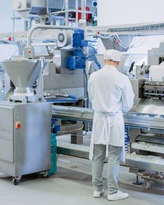 Food processing with workers evaluating machine workers
