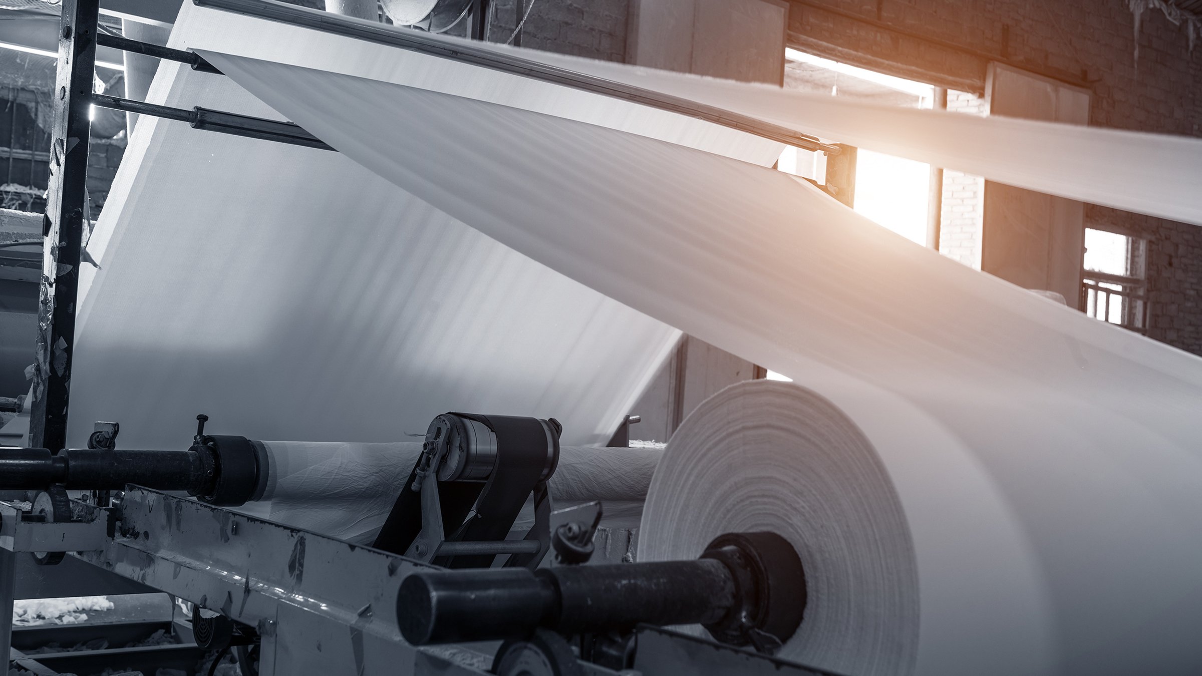 Large paper roll feeding into machine