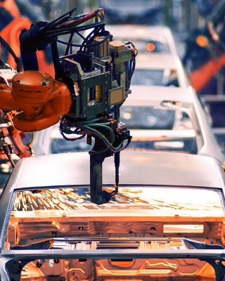 Robotic arms on assembly line making cars