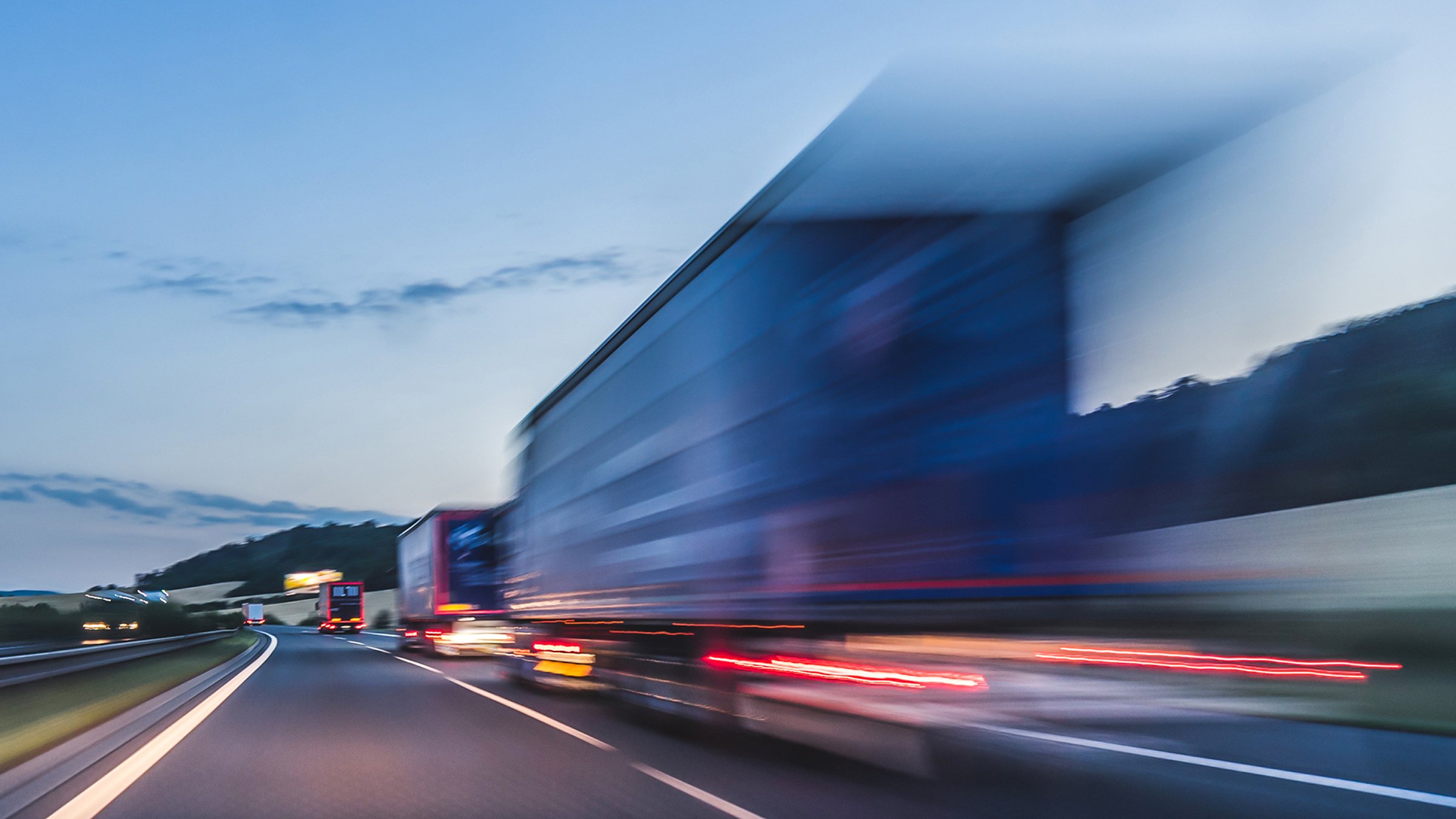 Trucks moving in blur at high speed