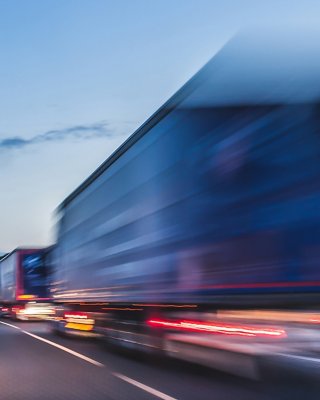 Trucks moving in blur at high speed