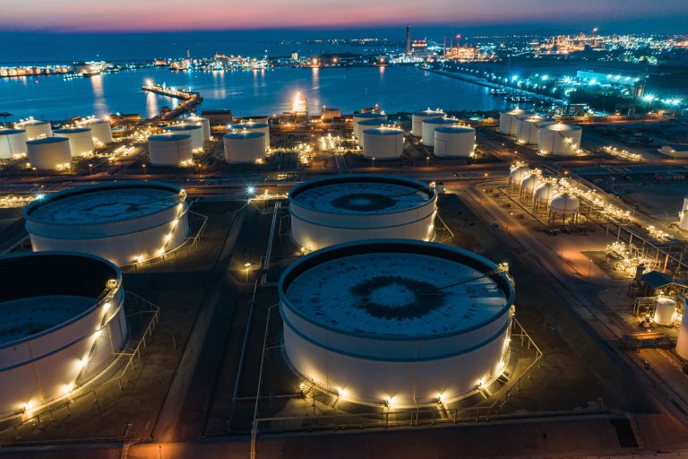 Aerial morning sun at world-class oil refinery, Petroleum refinery in the industrial factory of heavy industry zone, oil production plant, industrial process plant, oil storage tank and pipeline steel
