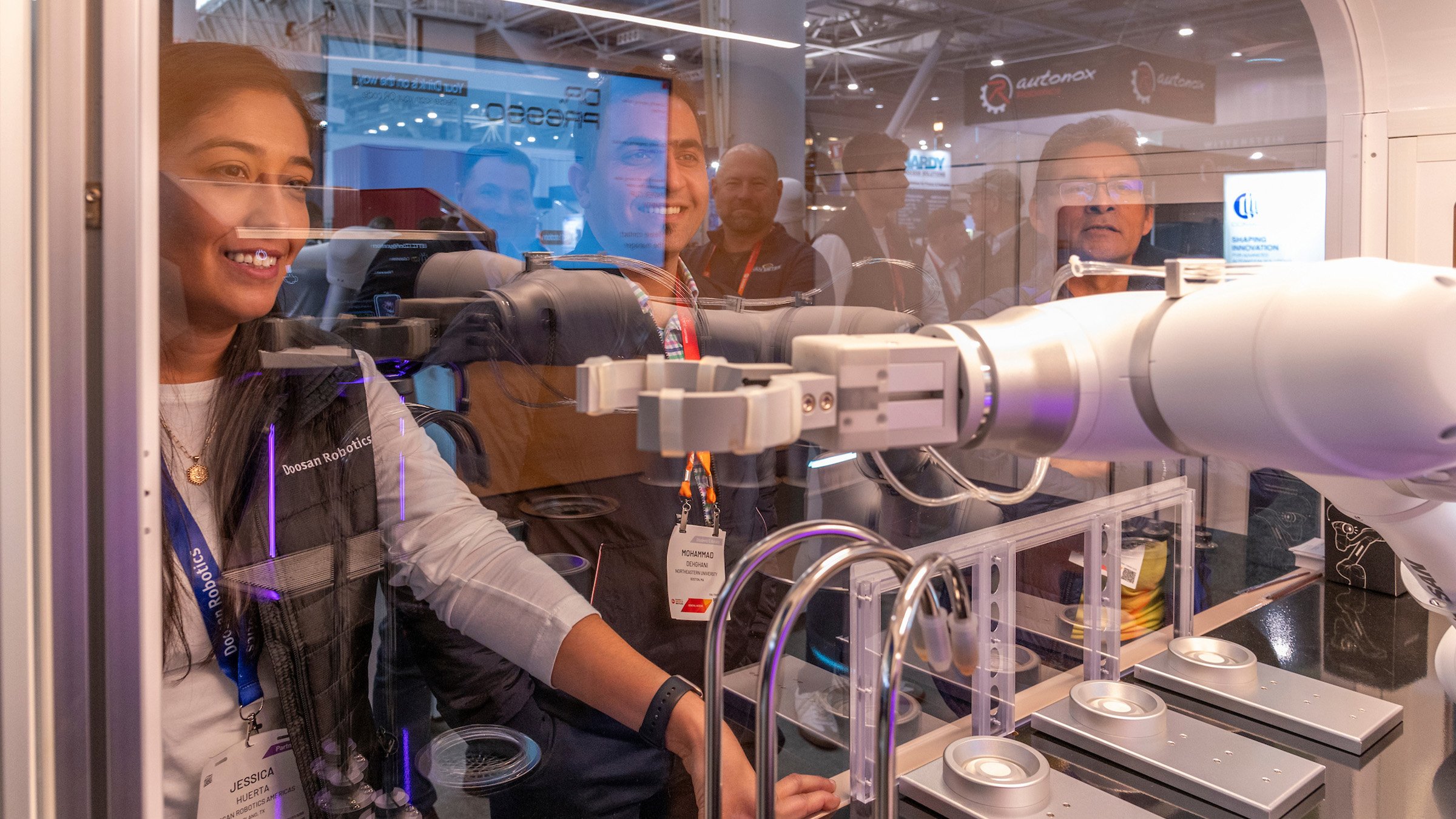 A woman looks at a machine at the Automation Fair expo