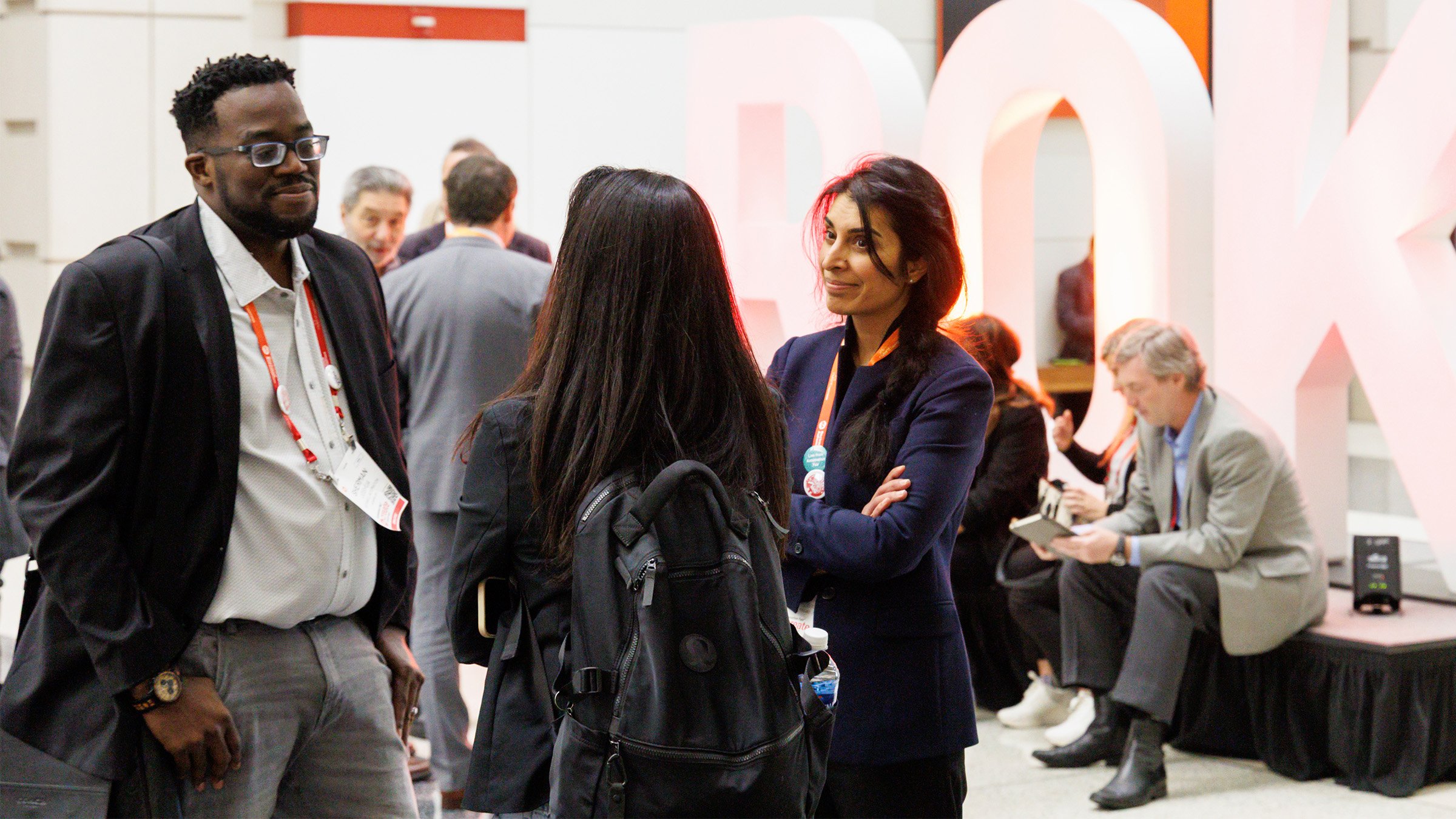 Three people networking at Rockwell's Automation Fair