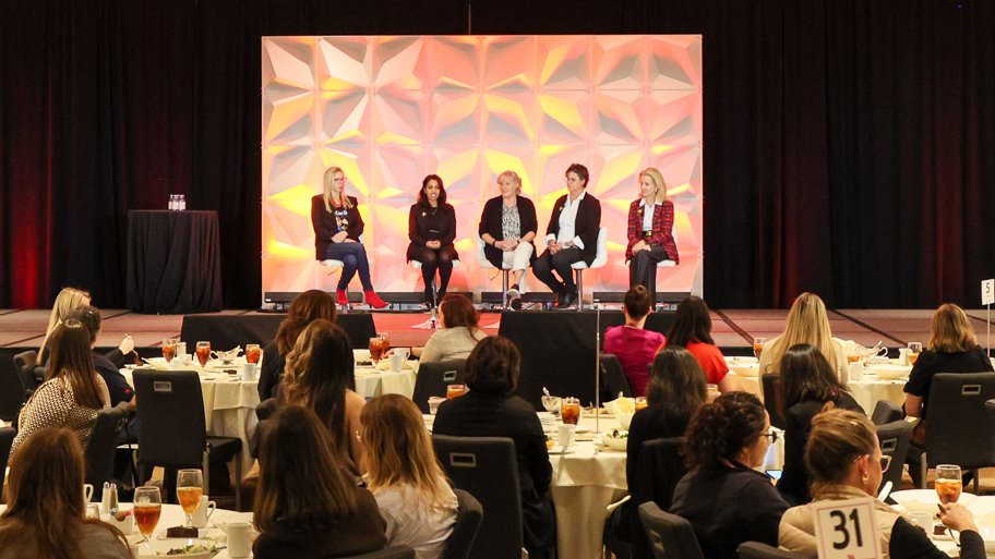 Women sitting on a panel on stage at the Automation Fair event
