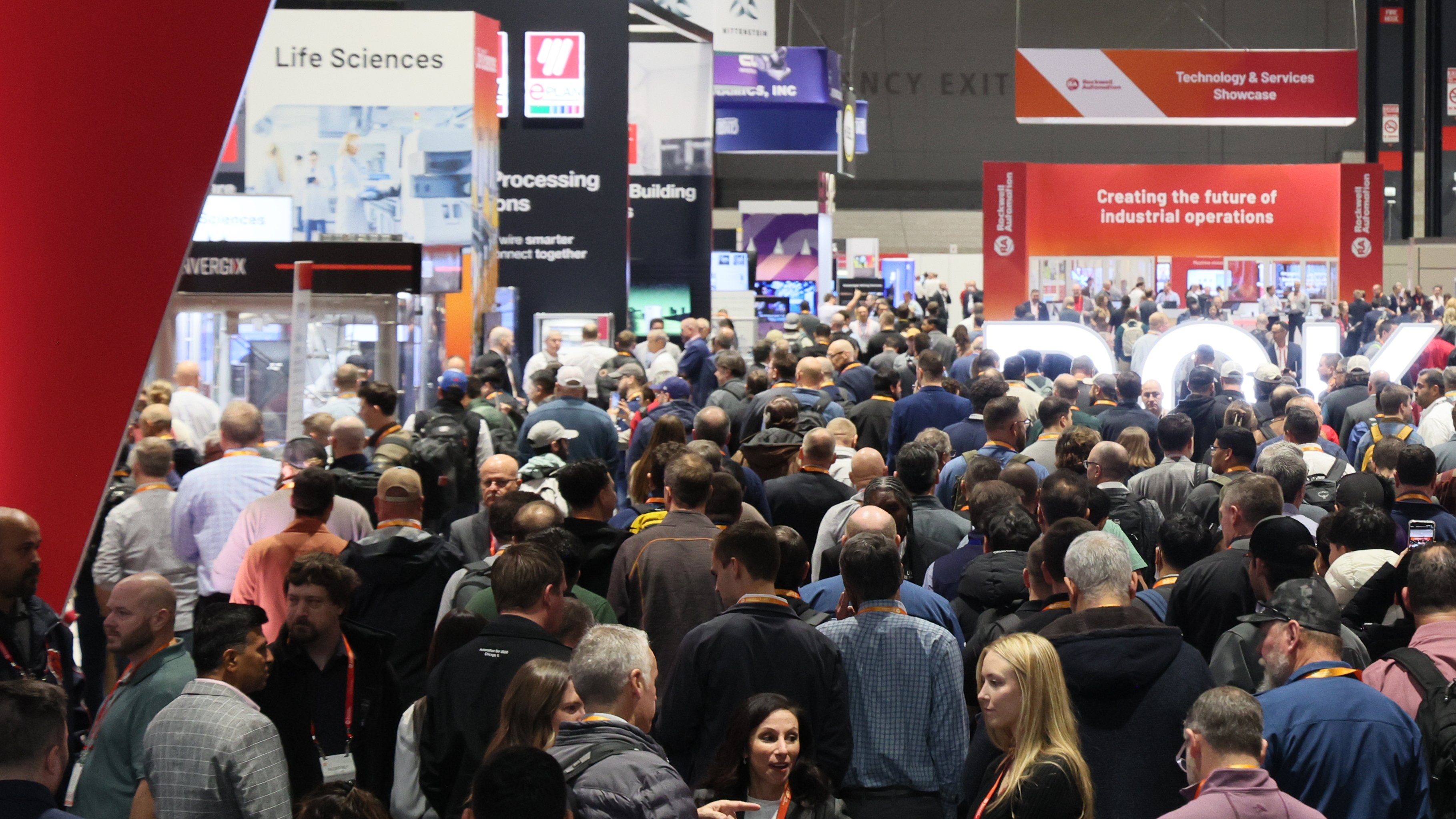 A crowd of people enter the Automation Fair exhibit hall