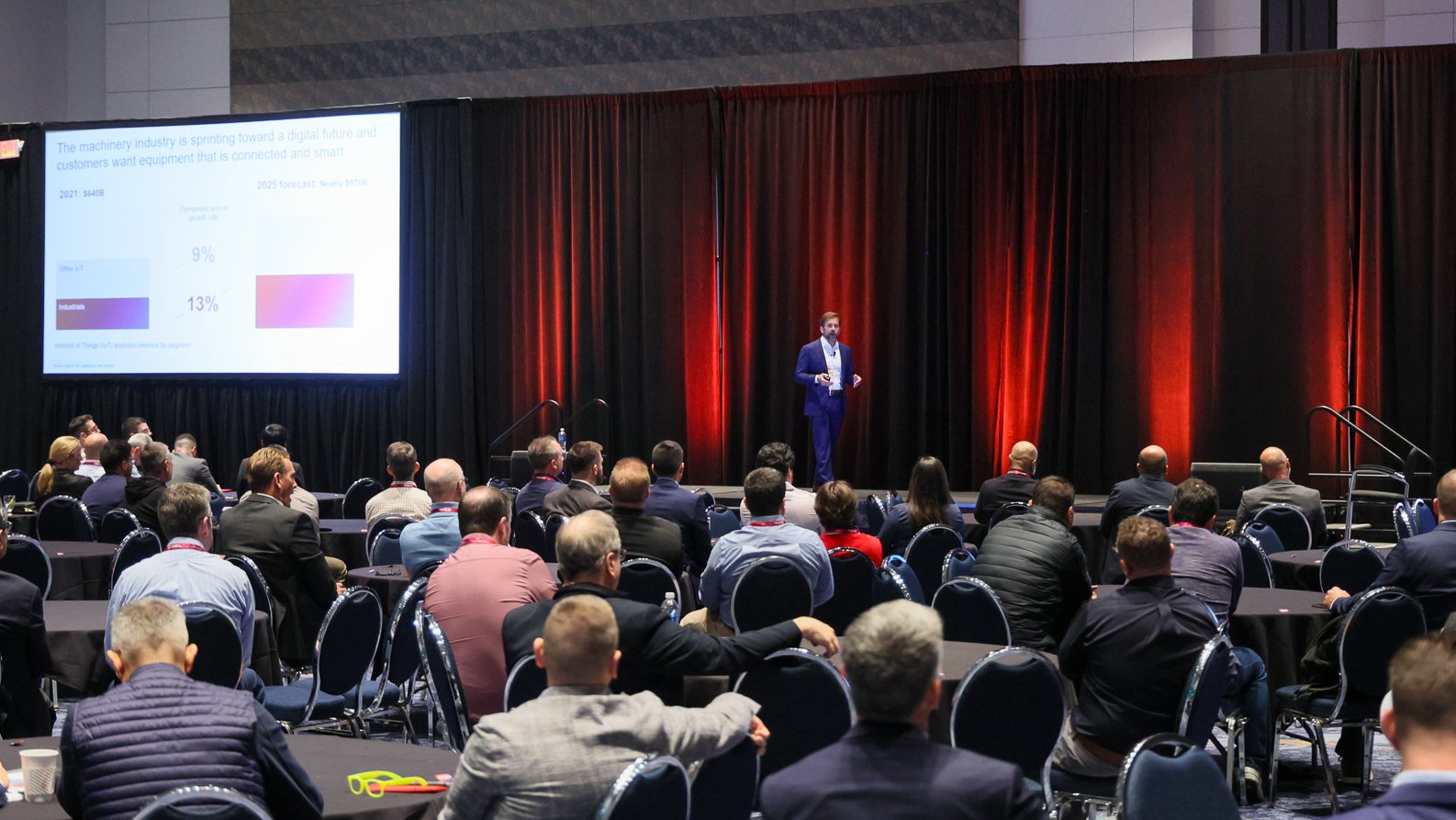 A man presents near a screen at the Automation Fair event