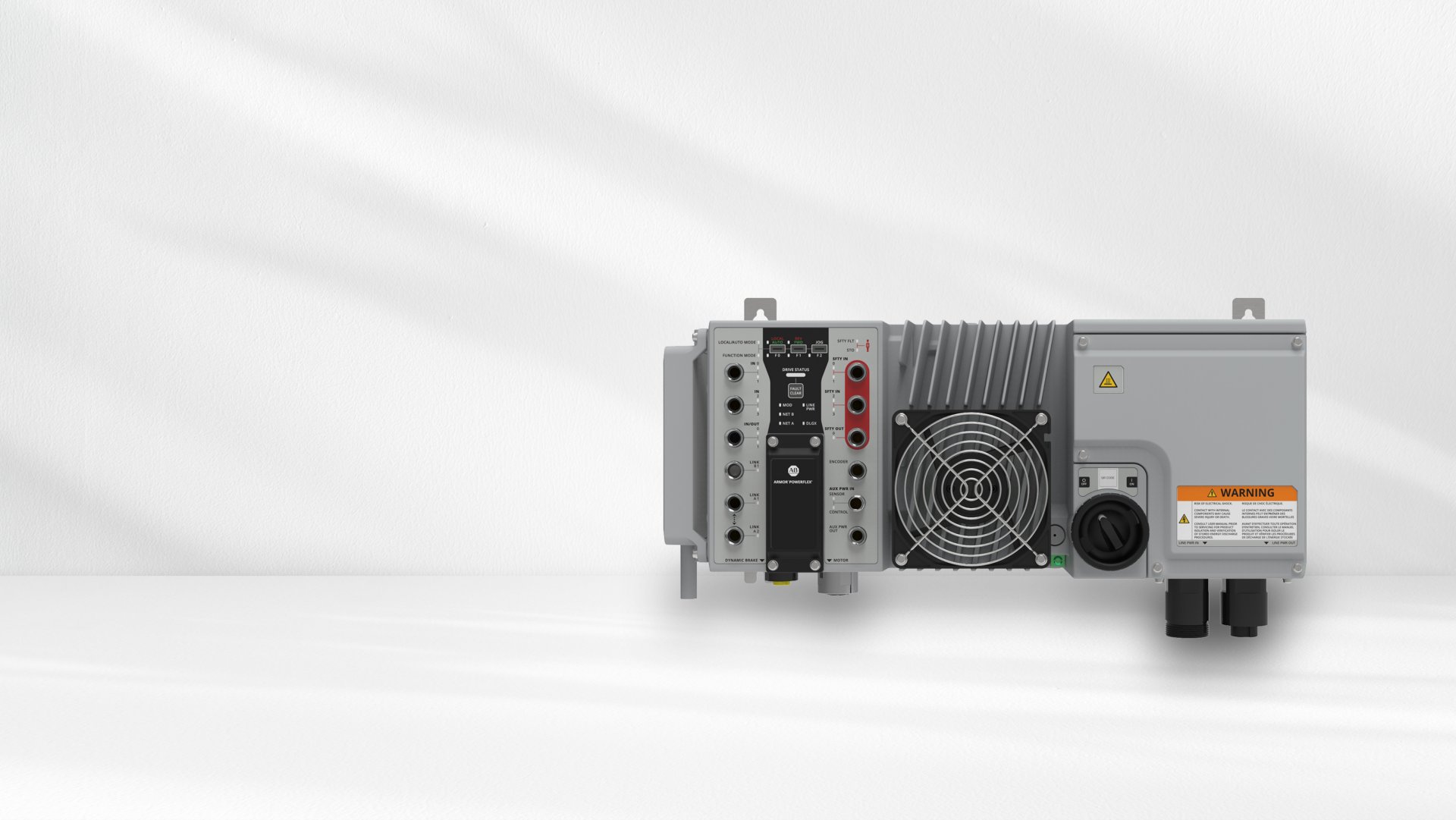 Horizonal view of an Armor PowerFlex Drive. It is gray in color with black text. There are several input holes on the left side. There is a fan in the middle. A round knob sits on the right side.