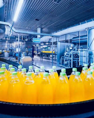 Beverage factory interior. Conveyor with bottles for juice or water. Modern equipments.